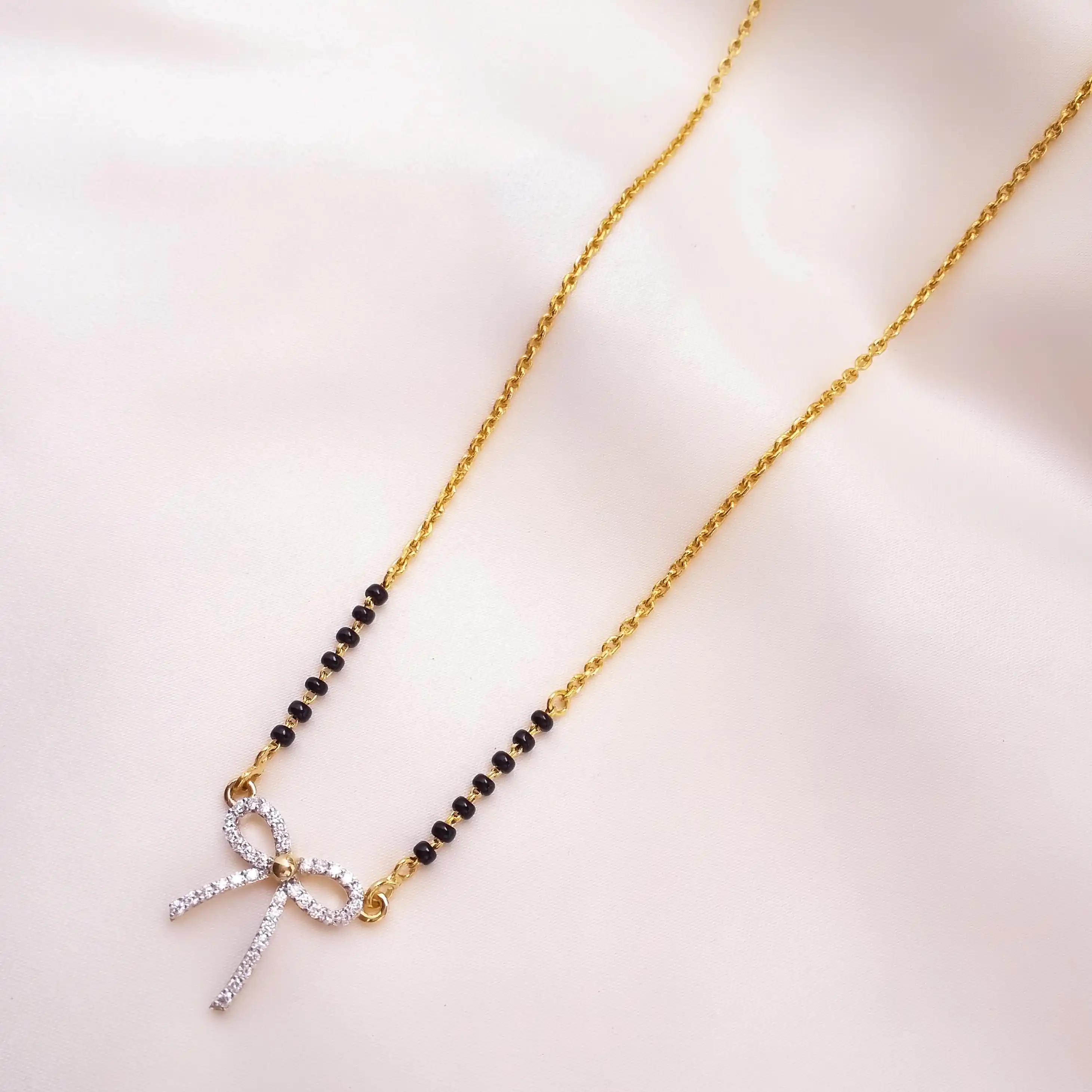 Buy Commit Bow Diamond Mangalsutra 18 KT yellow gold (7.15 gm). | Online By Giriraj Jewellers
