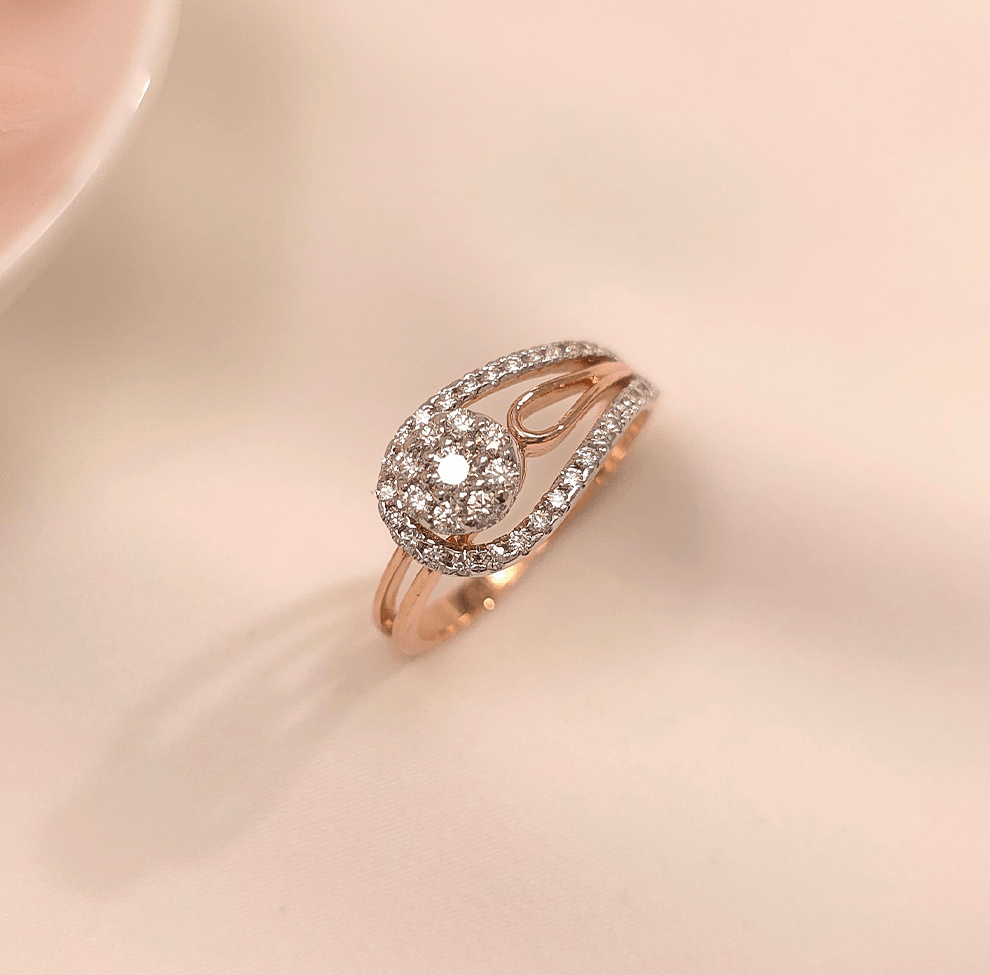 Buy Cori Rose Gold Diamond Ring 18 KT rose gold (3.37 gm). At Best Price In India. Check Rings New Designs At Giriraj Jewellers. BIS Care, Hallmark, 100% Certified | Trust & Quality of Giriraj Jewellers India | best diamond ring for engagement | Buy 18K Real Diamond Ring | buy diamond ring online | diamond ring designs | precious diamond wedding jewellery | trendy diamond rings for women | certified diamond ring collection | latest diamond jewellery designs | real diamond ring for women | solitaire designer jewellery